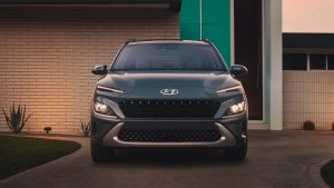 Close view of the front of a dark green 2022 Hyundai Kona parked in front of a house. | Hyundai dealer in Fort Smith, AR.