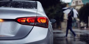 Rear corner view of a silver Hyundai Accent with the brake light on. | Brake repair in Fort Smith, AR