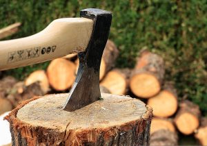 An axe in the top of a piece of wood. | Axe throwing | Fun activities around Fort Smith, AR.