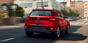 Rear view of a red 2020 Hyundai Venue being driven. | Hyundai service center in Fort Smith, AR.