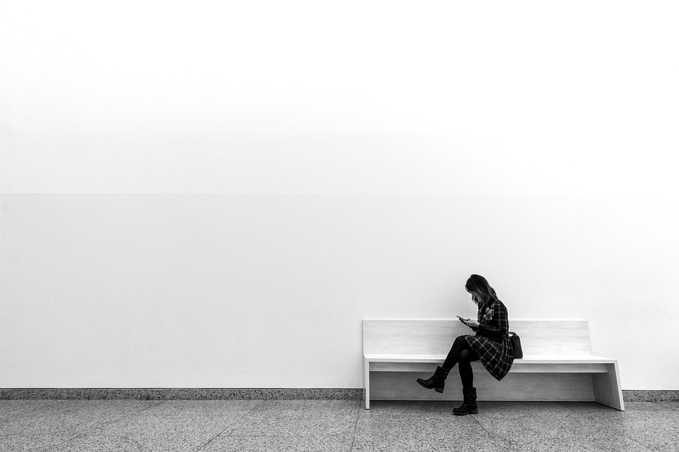 A woman sitting on a bench in a museum. | Tourist attractions in Fort Smith, AR.