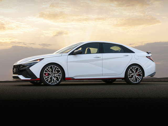 Profile view of a parked, white 2023 Hyundai Elantra N. | Hyundai dealer in Fort Smith | Crain Hyundai of Fort Smith