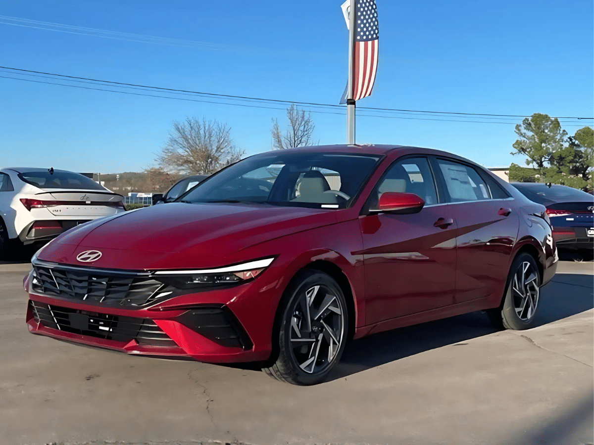 Side-by-side lineup of 2025 Hyundai Elantra trims in various colors, parked in front of Crain Hyundai of Fort Smith dealership.