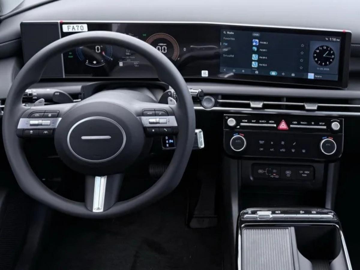 The modern interior of a 2026 Hyundai Tucson Hybrid at Crain Hyundai of Fort Smith, showcasing the technology covered by America's Best Warranty.